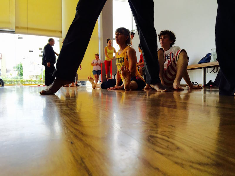 Dancers sit on the floor and stretch in an Athens studio